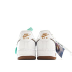 Nike Air Force 1 low-top sneakers heel view, white leather with brown sole and teal tag