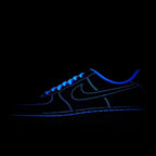 Low-top sneakers with blue glowing trim, dark blue upper with black outsole