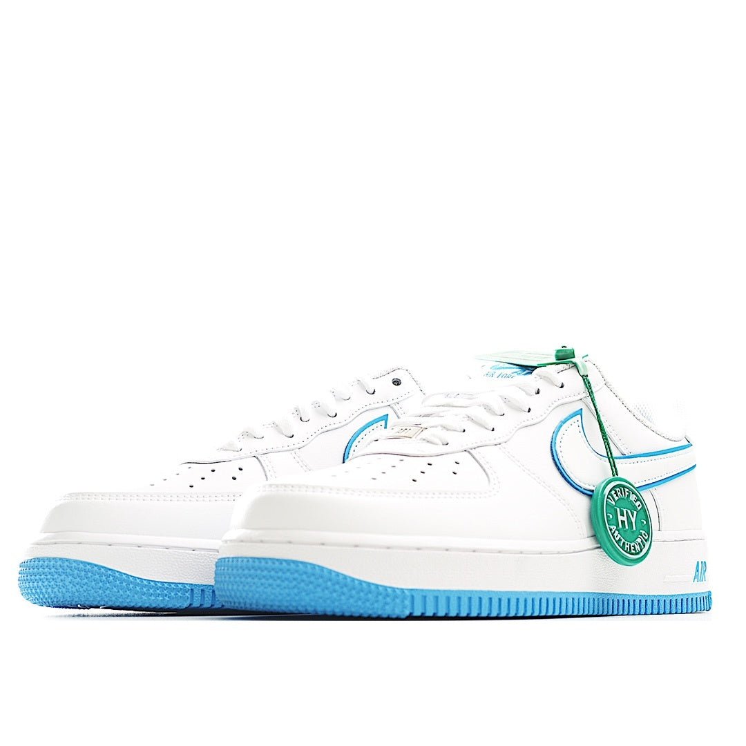 White low-top sneaker side view, blue swoosh and outsole, green lace tag.