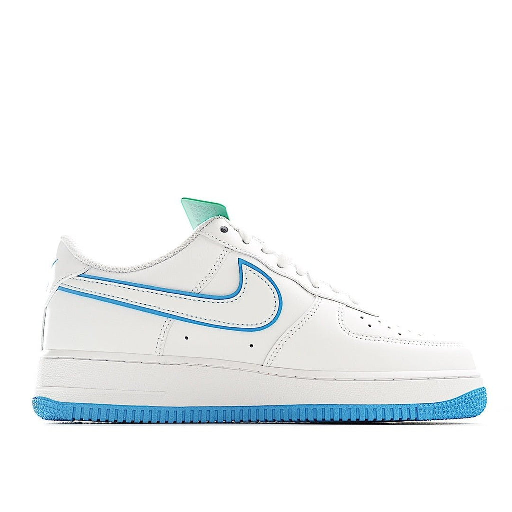 White low-top sneaker with blue swoosh and stripe, green collar tab, lace-up.