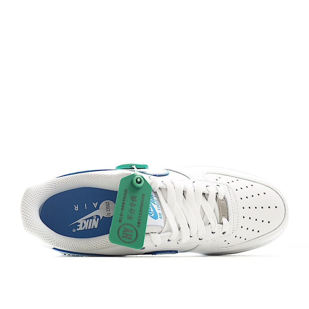 White sneaker from inside, showing blue insole and green lace tag on laces.