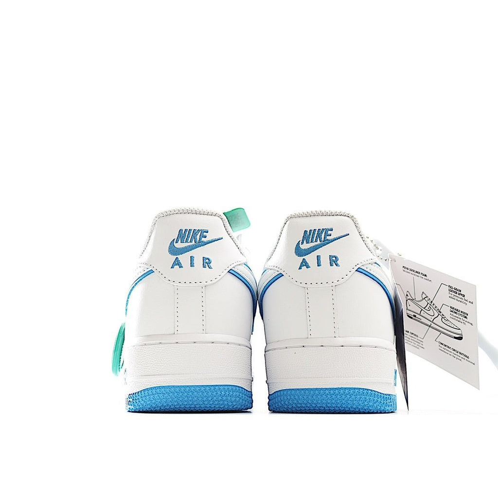 White sneakers back view with blue accents and green lace tags, plus hanging label.