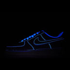 Dark blue low-top sneaker with neon-blue outline and swoosh, lace-up.