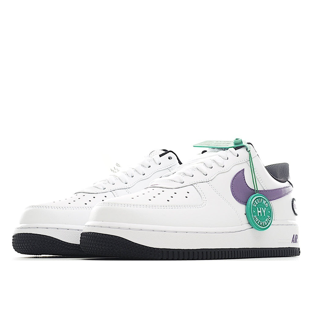 White low-top sneaker with purple swoosh panel, green tag, and black sole edge