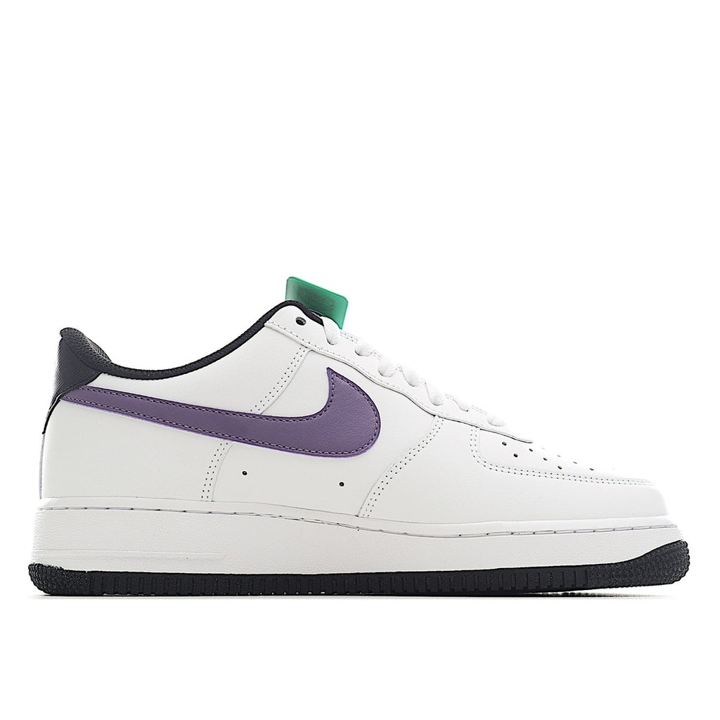 White low-top sneaker with purple swoosh and green lace accent, black rubber outsole