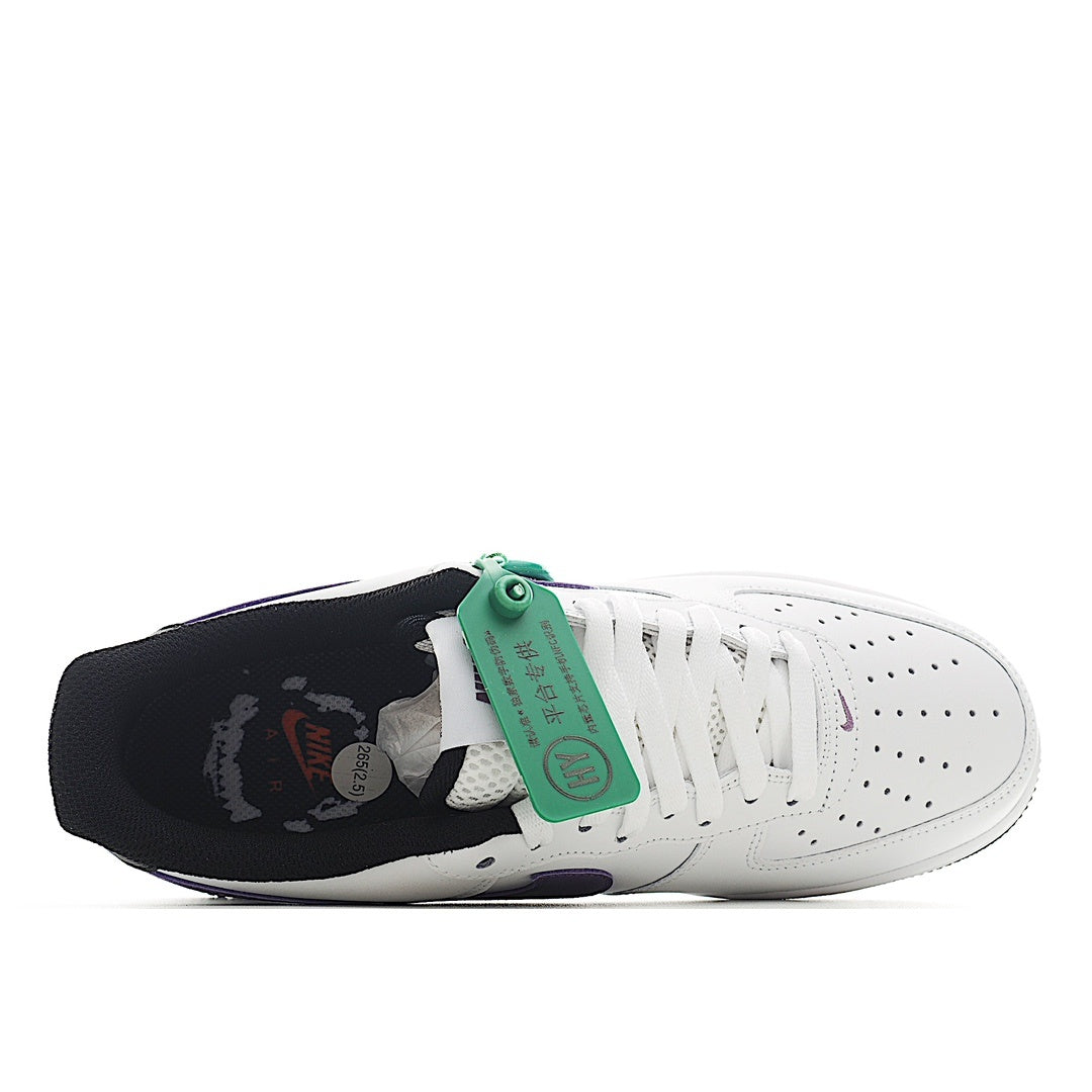White low-top sneaker with purple swoosh, green tag, dark heel cup, and black sole