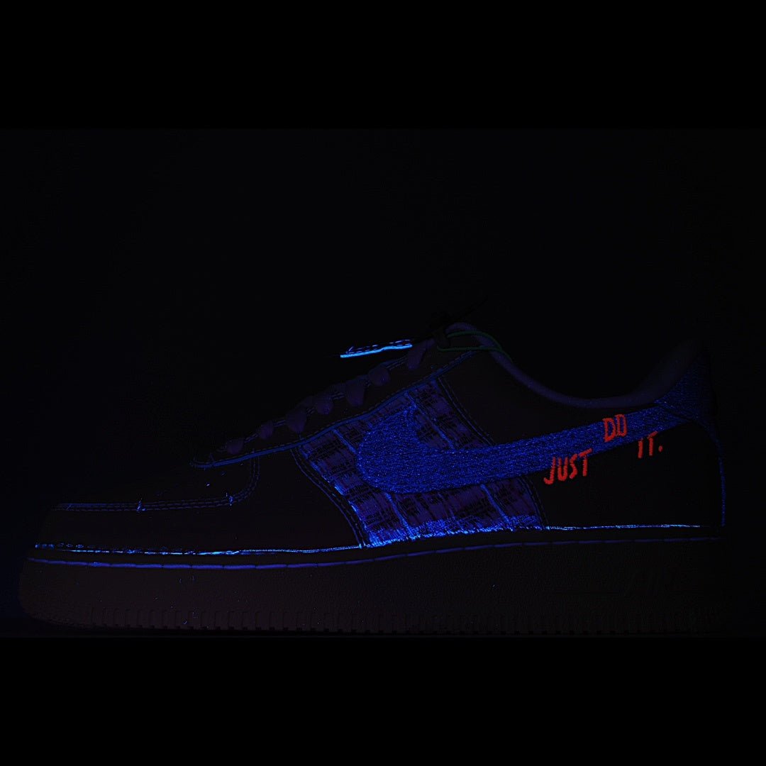 Air Force 1 sneaker, dark blue with lace-up front and 'JUST' accent stitching
