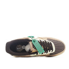 Tan suede Nike sneaker open view with dark lining, green lace tie, white midsole
