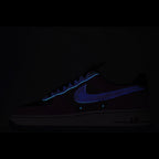 Dark navy Nike athletic sneaker with blue swoosh and AIR branding on sole