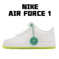 White low-top leather sneakers with green lace accents and neon yellow sole