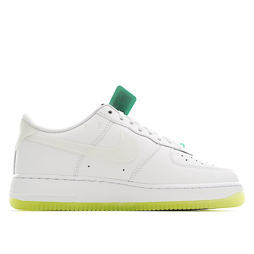 White low-top sneakers with green lace accents and perforated toe