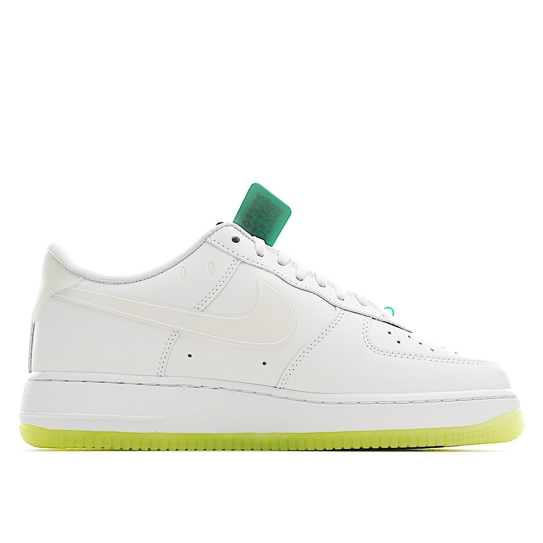 White low-top sneakers with green lace accents and perforated toe