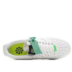 White low-top sneaker with open collar, green floral lining, and neon yellow sole