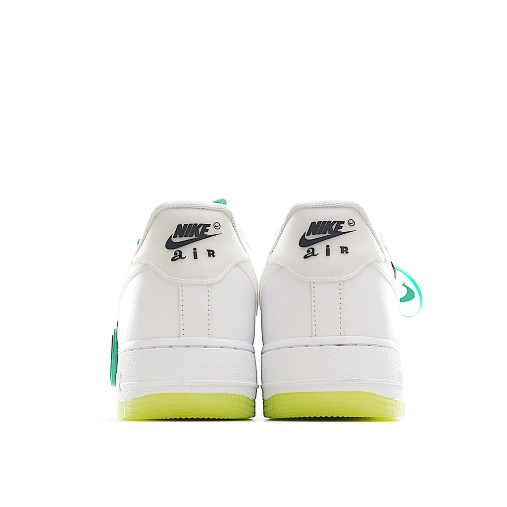 Pair of white low-top sneakers showing heel tabs and neon yellow outsole