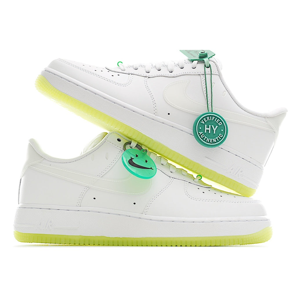 White low-top sneakers with green lace tag, neon yellow sole, and side swoosh
