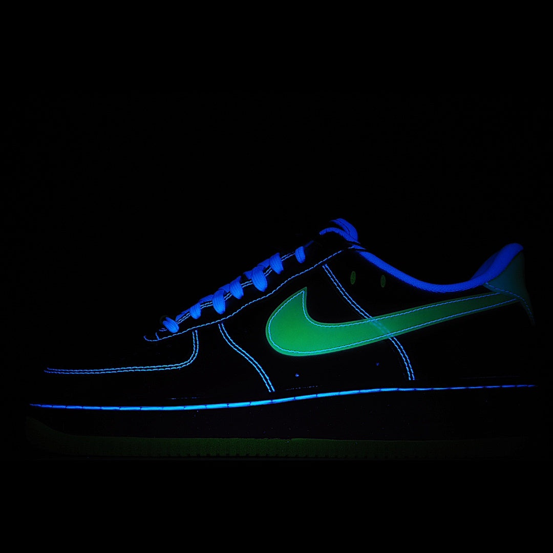Dark low-top sneakers with blue glowing lines and green swoosh