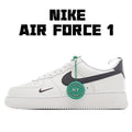 White low-top sneaker with black swoosh and green lace accent