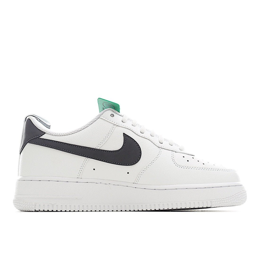 White leather sneaker with black swoosh stripe and green inner tongue label
