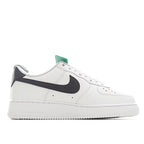 White leather sneaker with black swoosh stripe and green inner tongue label