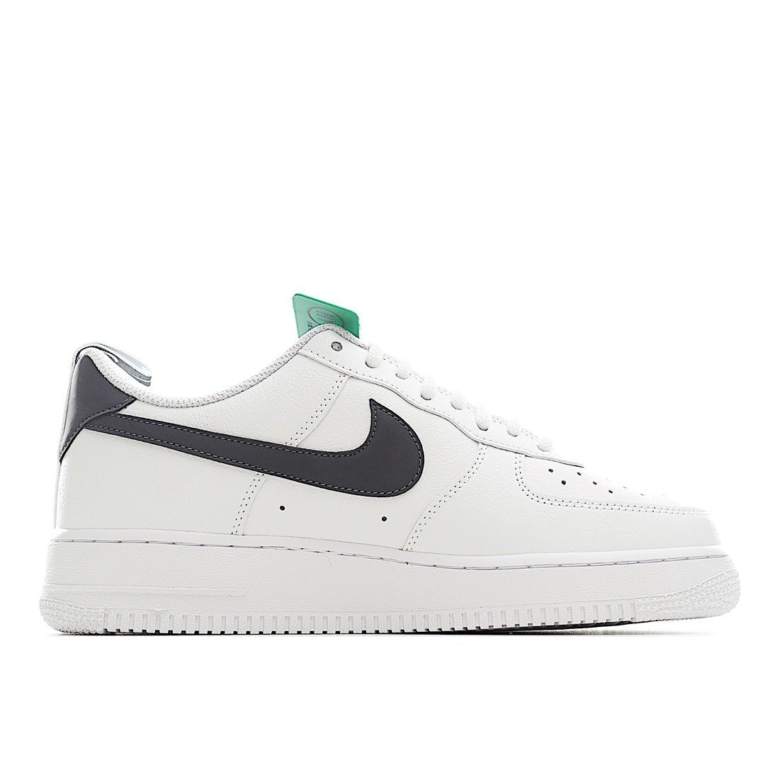 White leather sneaker with black swoosh stripe and green inner tongue label