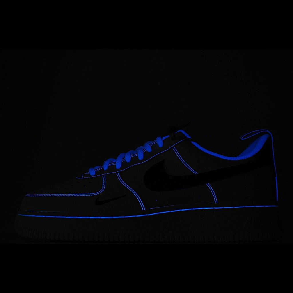 Dark blue low-top sneaker with black swoosh and blue stitching accents