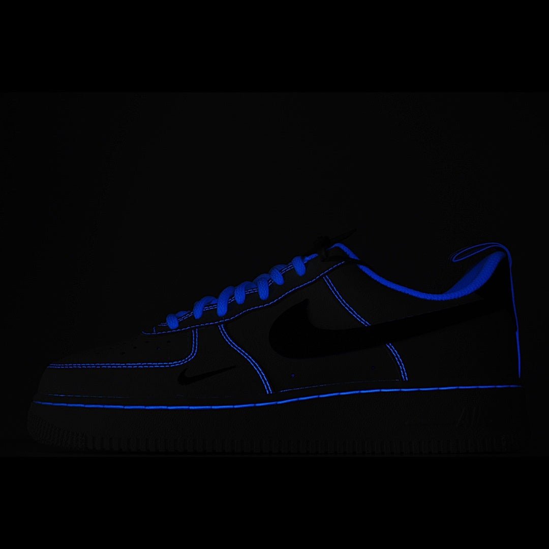 Dark blue low-top sneaker with black swoosh and blue stitching accents