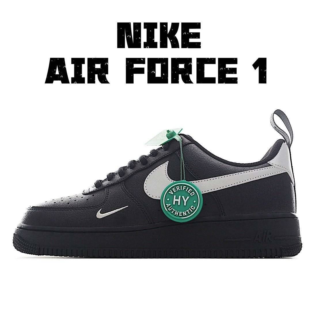 Black low-top sneakers with white side panel and green HY tag, Nike Swoosh