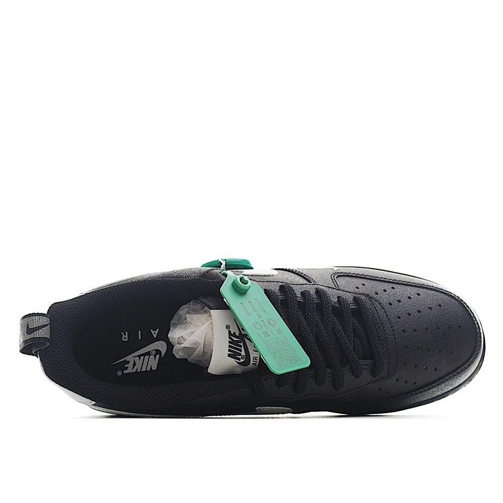 Nike Air Force 1 low-top sneakers, black side profile with green hanging tag