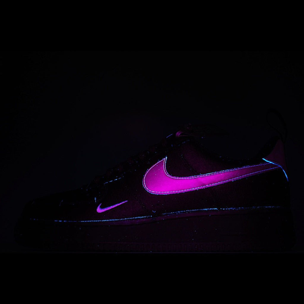 Black Nike Air Force 1 sneakers with purple glowing swoosh detail
