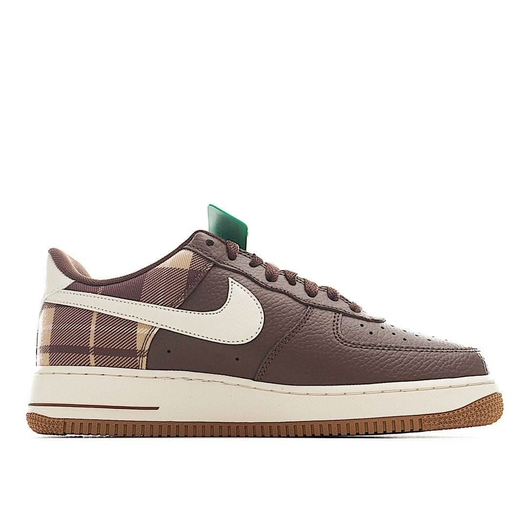 Low-top sneakers with brown leather, white swoosh, tartan plaid side panel, green lace tab