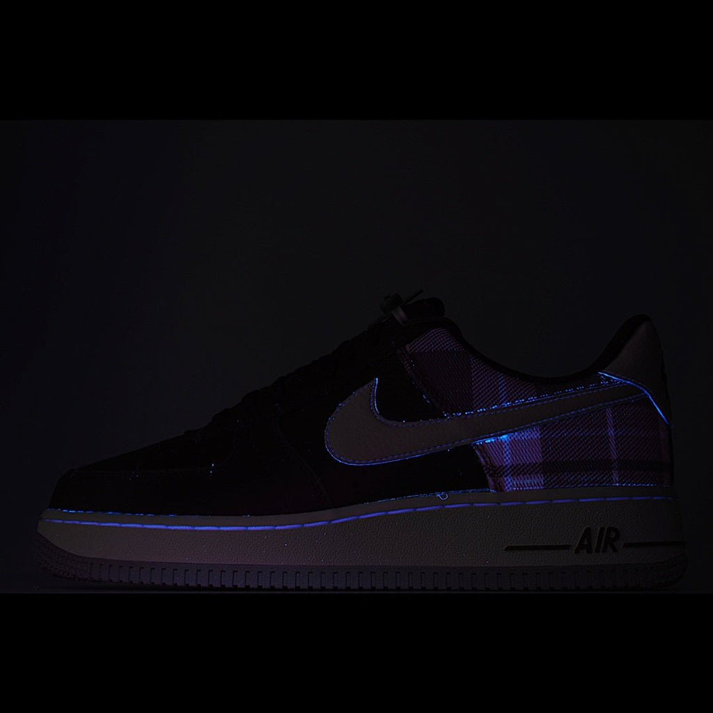 Dark low-top sneaker with blue swoosh and subtle plaid accents, AIR text on side