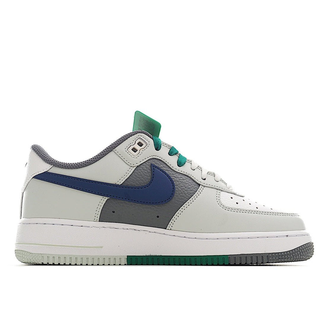 White low-top sneaker with blue Swoosh, gray panels, and green lace trim