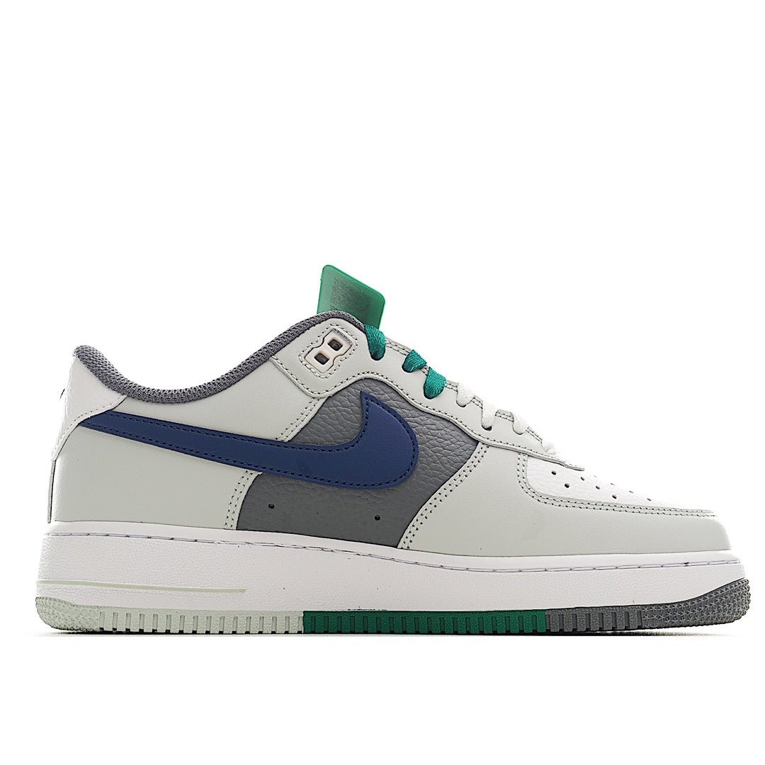 White low-top sneaker with blue Swoosh, gray panels, and green lace trim
