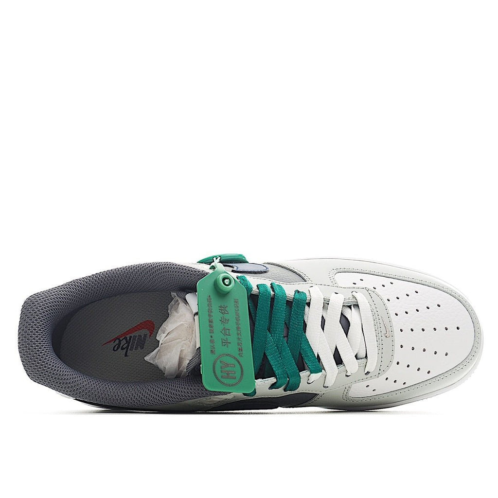 Low-top sneaker with open collar showing green laces and blue/gray upper panels