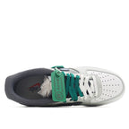 Low-top sneaker with open collar showing green laces and blue/gray upper panels