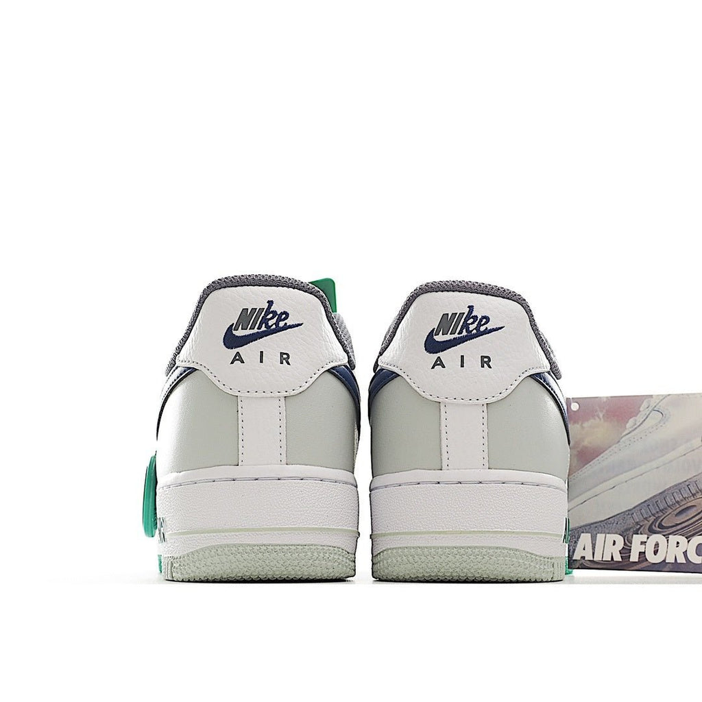 Back view of white low-top sneaker with Nike Air text and green lace accents