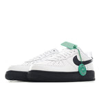 Low-top sneaker, white upper with black swoosh, green laces, and black outsole.