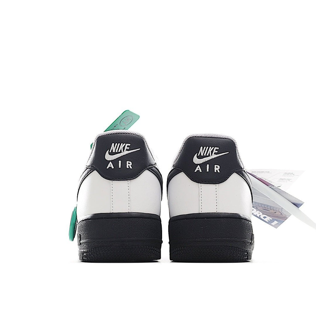 Low-top sneaker heels, white leather with black heel panels and green lace tab.