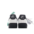 Low-top sneaker heels, white leather with black heel panels and green lace tab.