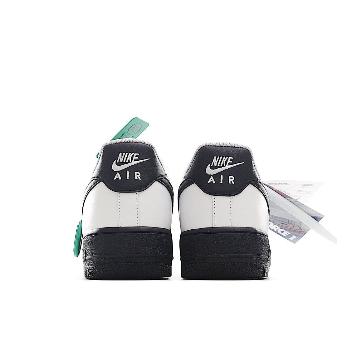 Low-top sneaker heels, white leather with black heel panels and green lace tab.