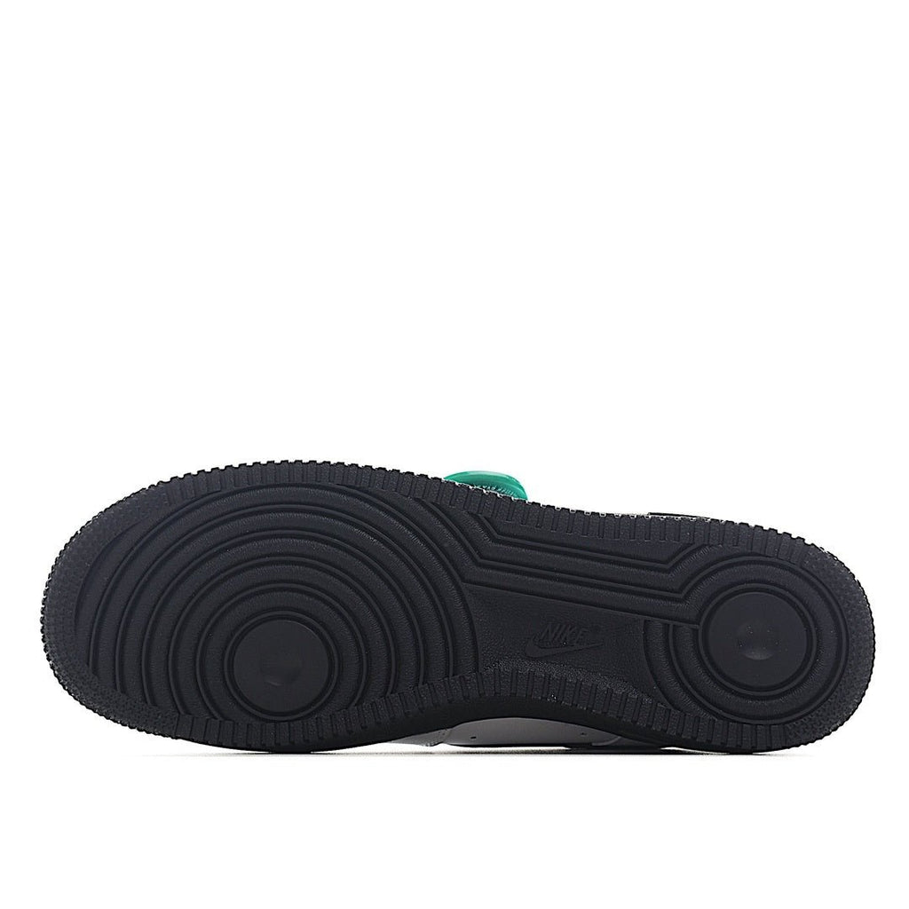 Low-top sneaker outsole, dark rubber tread with circular traction pattern.