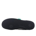 Low-top sneaker outsole, dark rubber tread with circular traction pattern.