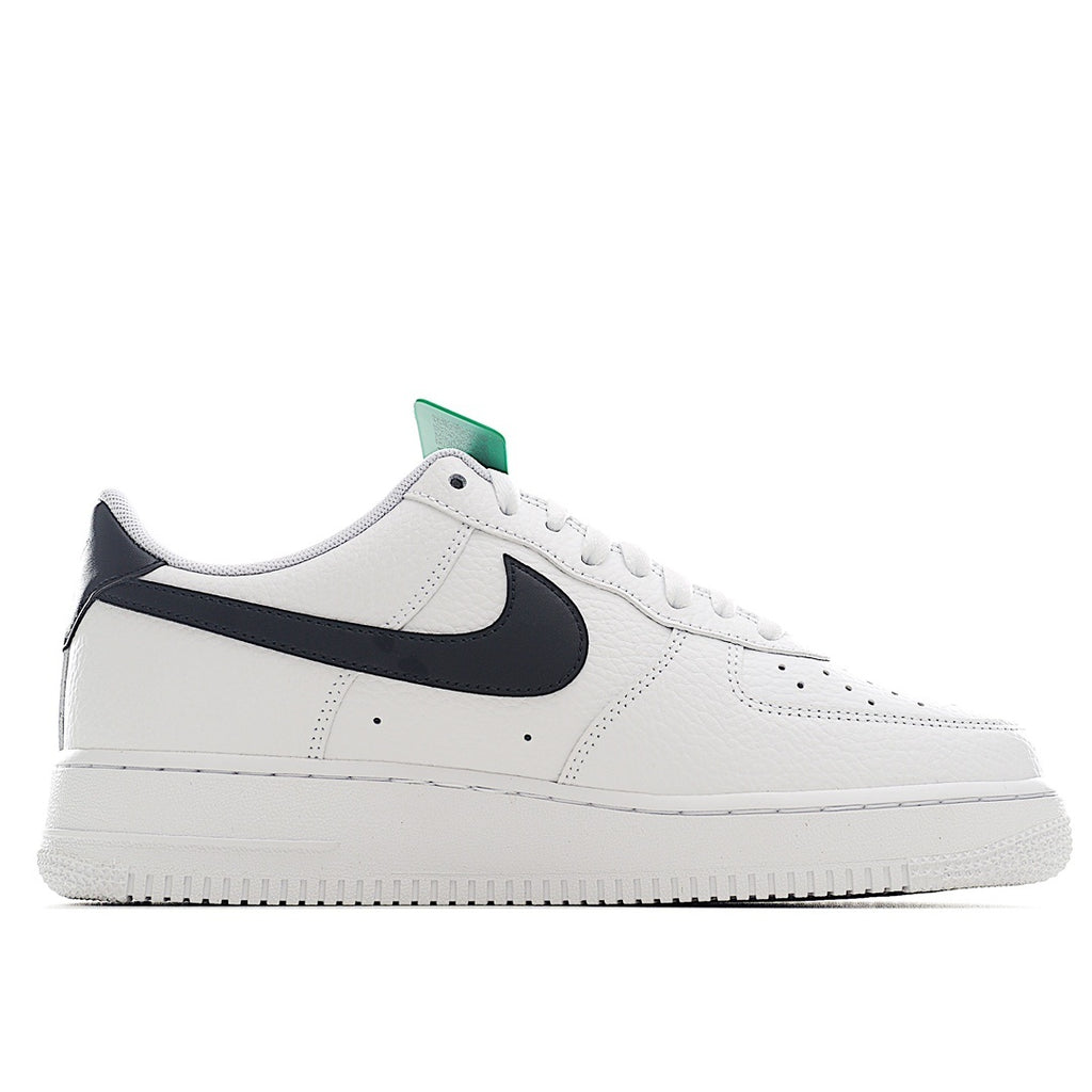 White Air Force 1-style sneaker with black swoosh and green collar tag