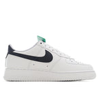White Air Force 1-style sneaker with black swoosh and green collar tag
