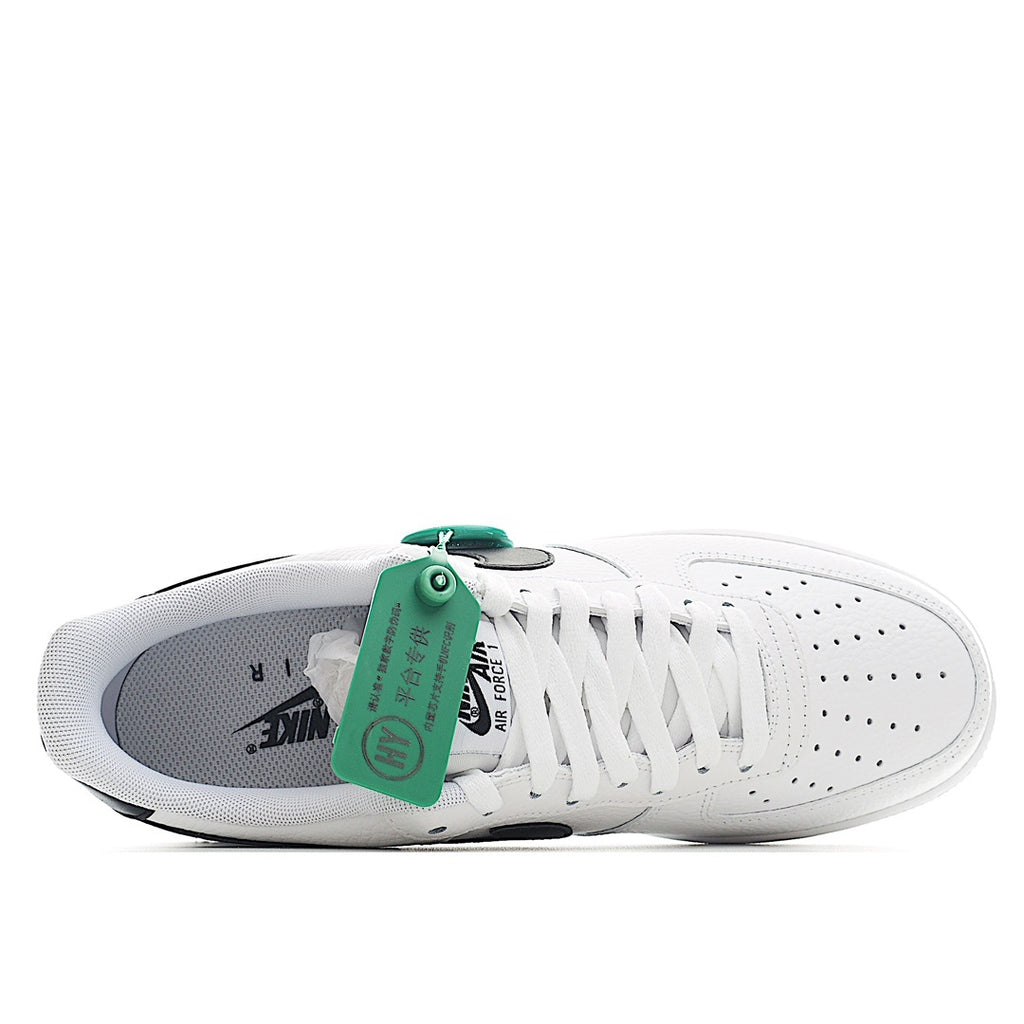 White leather sneaker with white laces, black heel detail, and green collar label