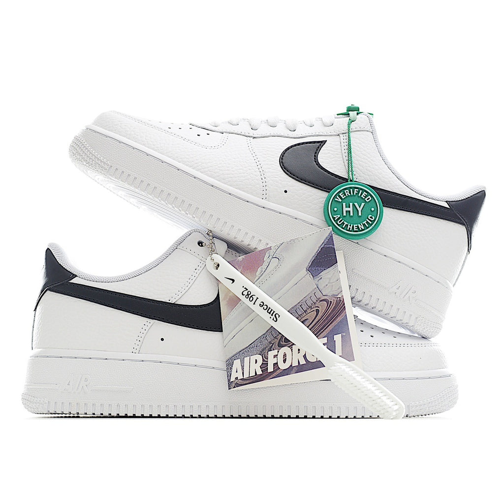 White leather sneaker with black swoosh, green tag, and visible side lace holes