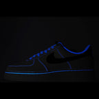 Dark blue low-top sneaker with black swoosh and blue contrast stitching