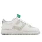 White Nike Air Force 1 low-top sneakers with teal heel tab and side swoosh