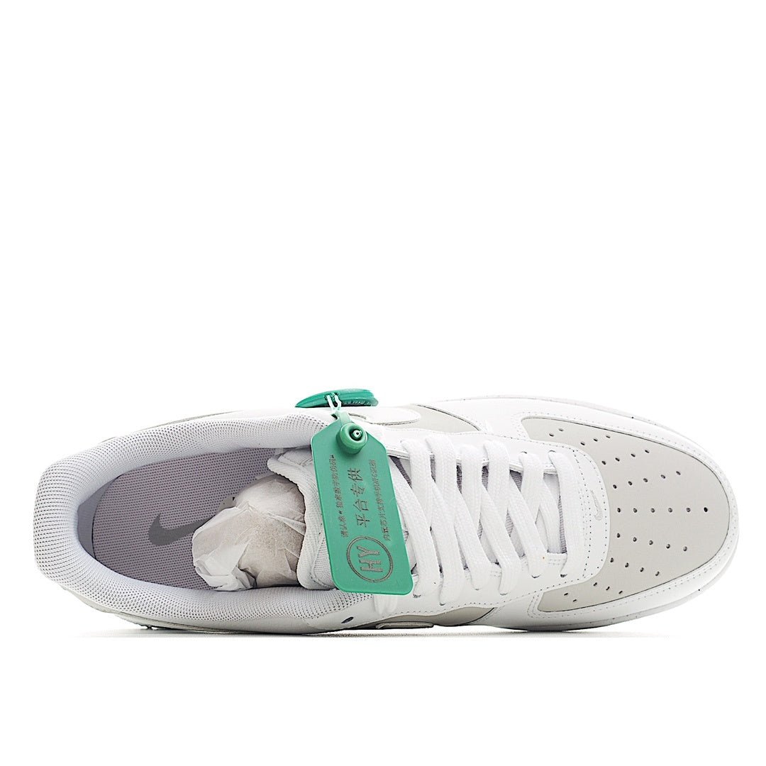 White Nike Air Force 1 low-top sneakers with visible interior lining and teal pull tab