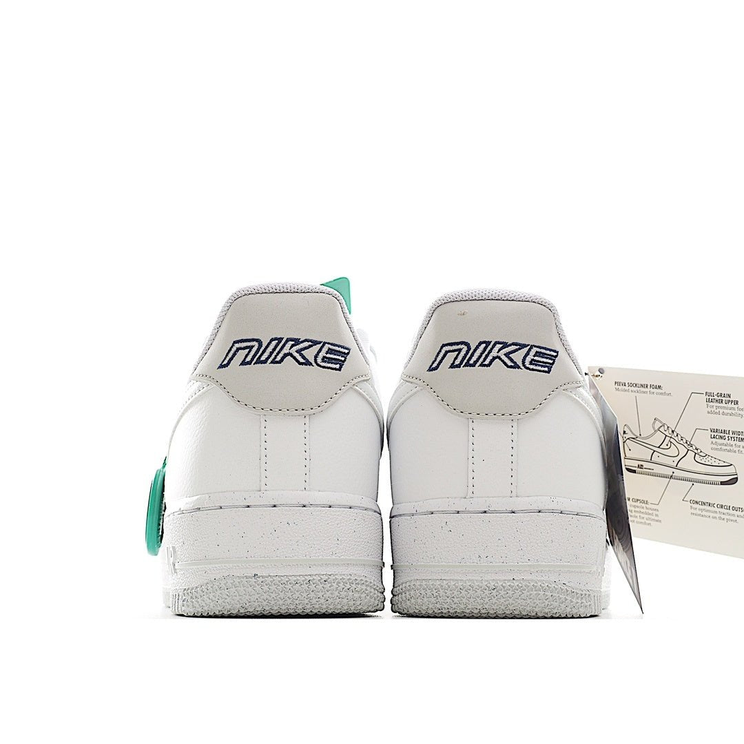 White Nike Air Force 1 low-top sneakers, showing heel with Nike branding and teal tab